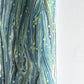 a sheet of Italian printed marbled wrapping paper by Tassotti with a marble pattern in aqua, blue, green, white an gold