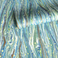 a sheet of Italian printed marbled wrapping paper by Tassotti with a marble pattern in aqua, blue, green, white an gold