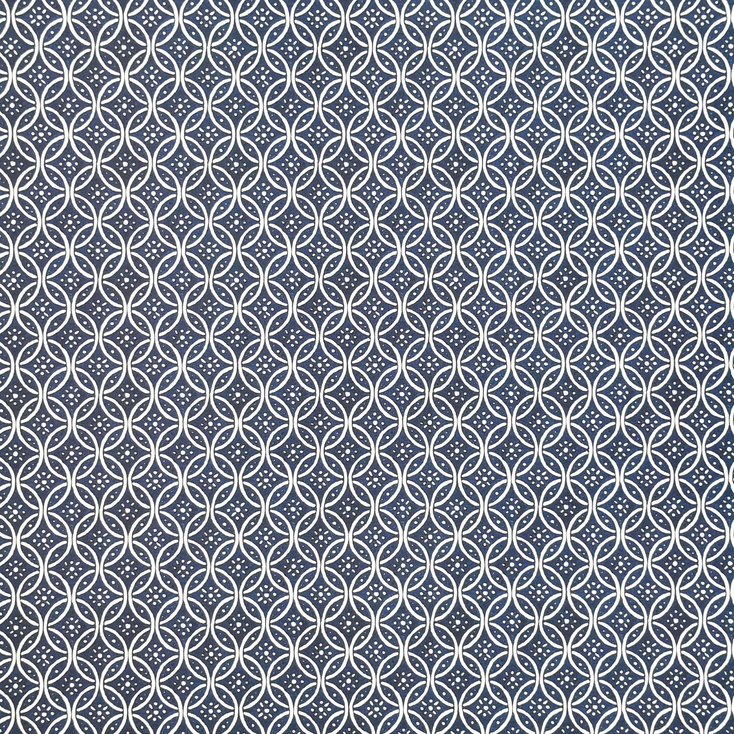 A sheet of Italian wrapping paper with a pattern of interlocking rings on a blue background.  