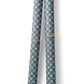 A sheet of Italian wrapping paper with a pattern of interlocking rings on a blue background.  Pictured rolled