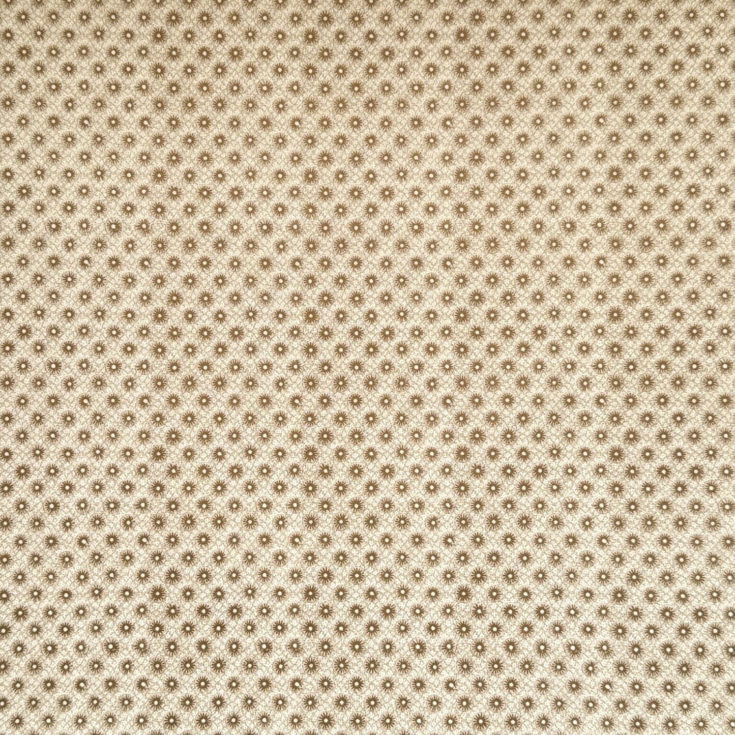a sheet of italian wrapping paper with gold snowflakes on a cream backdrop. 