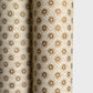 a sheet of italian wrapping paper with gold snowflakes on a cream backdrop. Close up