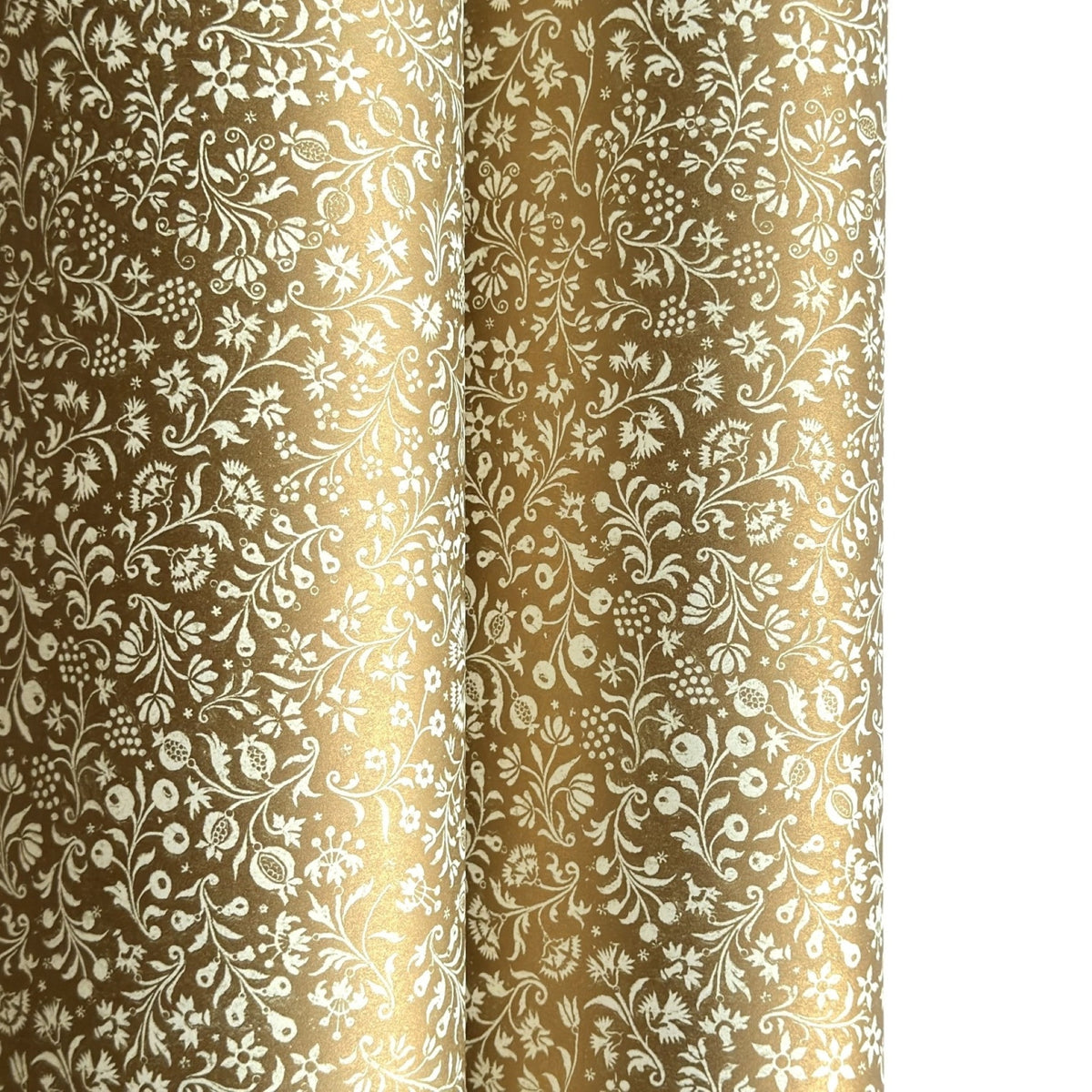 a sheet of Italian wrapping paper by Tassotti, the design is from the Remondini archives and is a small scale botanical block print on an antique gold ground