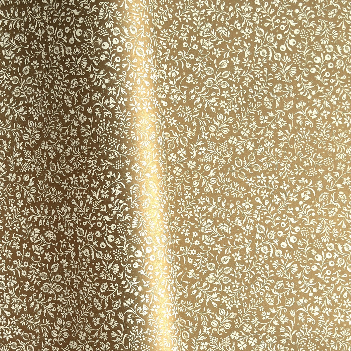 a sheet of Italian wrapping paper by Tassotti, the design is from the Remondini archives and is a small scale botanical block print on an antique gold ground