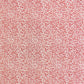 a sheet of italian wrapping paper with a small delicate floral pattern in red on white background