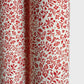 a sheet of italian wrapping paper with a small delicate floral pattern in red on white background