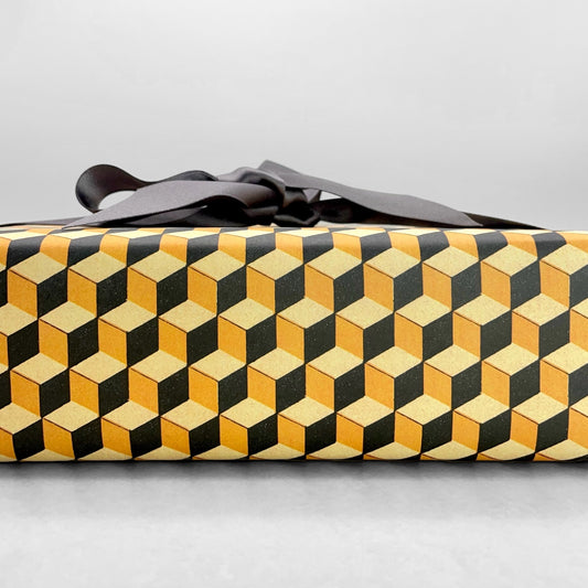 Italian patterned wrapping paper "Carta Varese" by Grafiche Tassotti. A pattern of yellow, black and lemon geometric cubes with a 3D effect