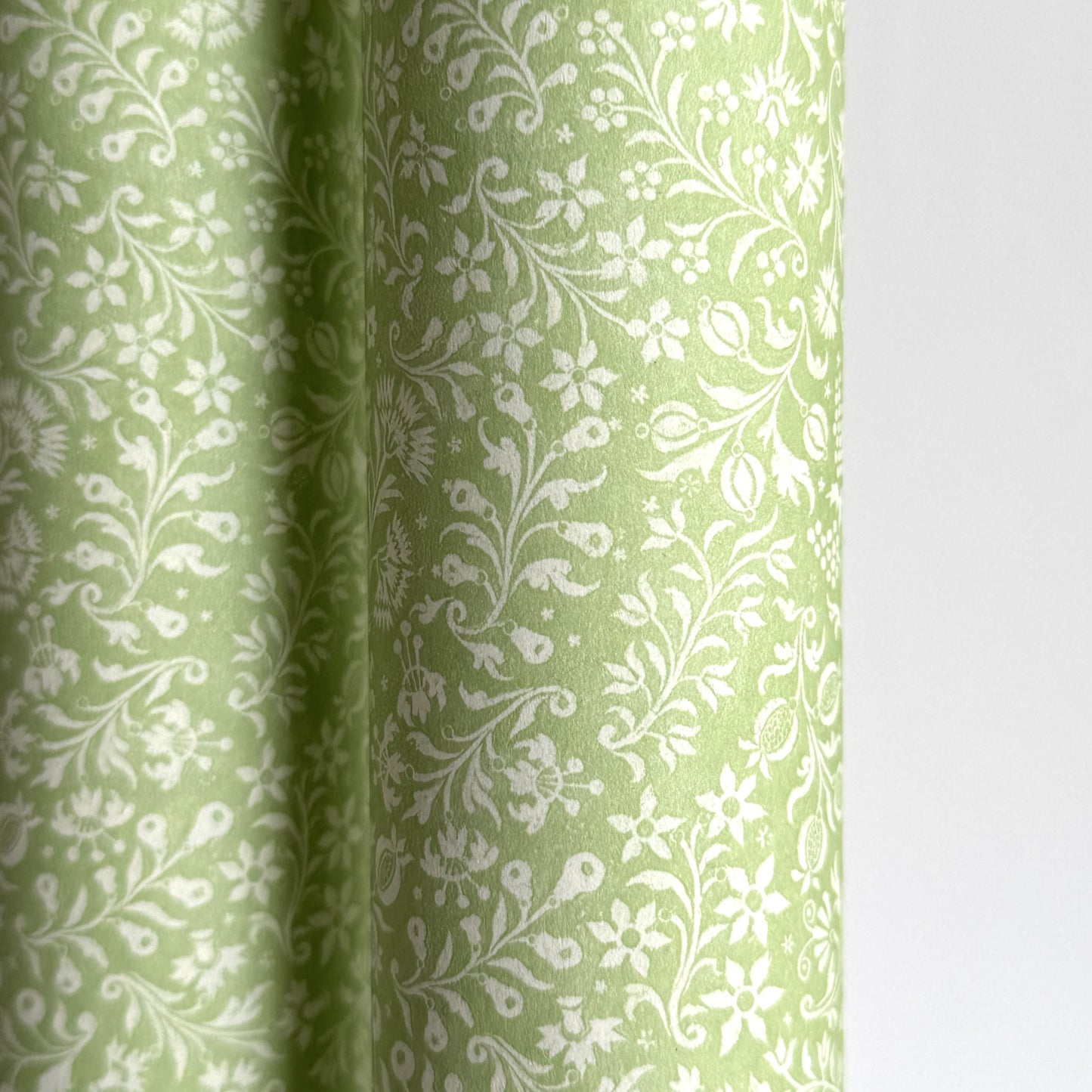 a sheet of italian wrapping paper with a delicate small floral design in light green and white