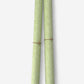 a sheet of italian wrapping paper with a delicate small floral design in light green and white. Pictured rolled