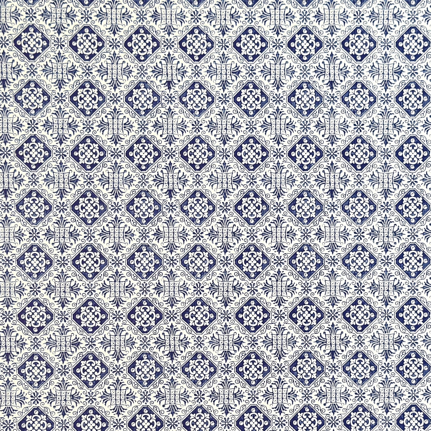 a sheet of italian wrapping paper with a blue block print repeat stamp pattern on white.
