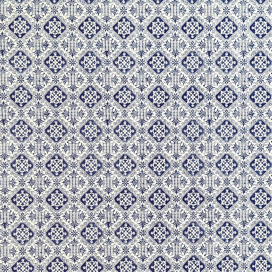 a sheet of italian wrapping paper with a blue block print repeat stamp pattern on white.