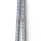 a sheet of italian wrapping paper with a blue block print repeat stamp pattern on white. Pictured rolled
