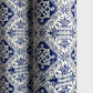a sheet of italian wrapping paper with a blue block print repeat stamp pattern on white.