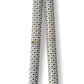 a sheet of italian wrapping paper with a blue little heart shaped leaves and red berries on white background. Pictured rolled