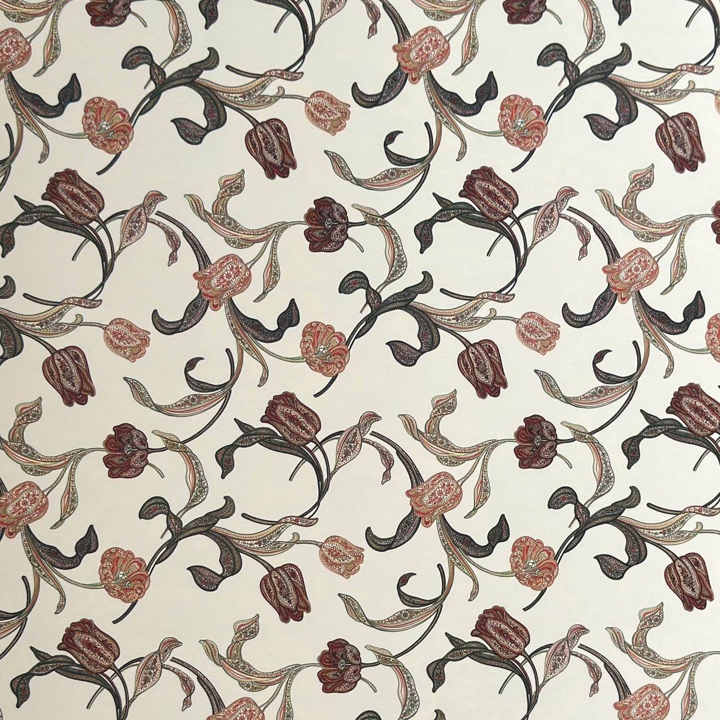 a sheet of italian wrapping paper with a multicoloured large floral pattern on cream paper 