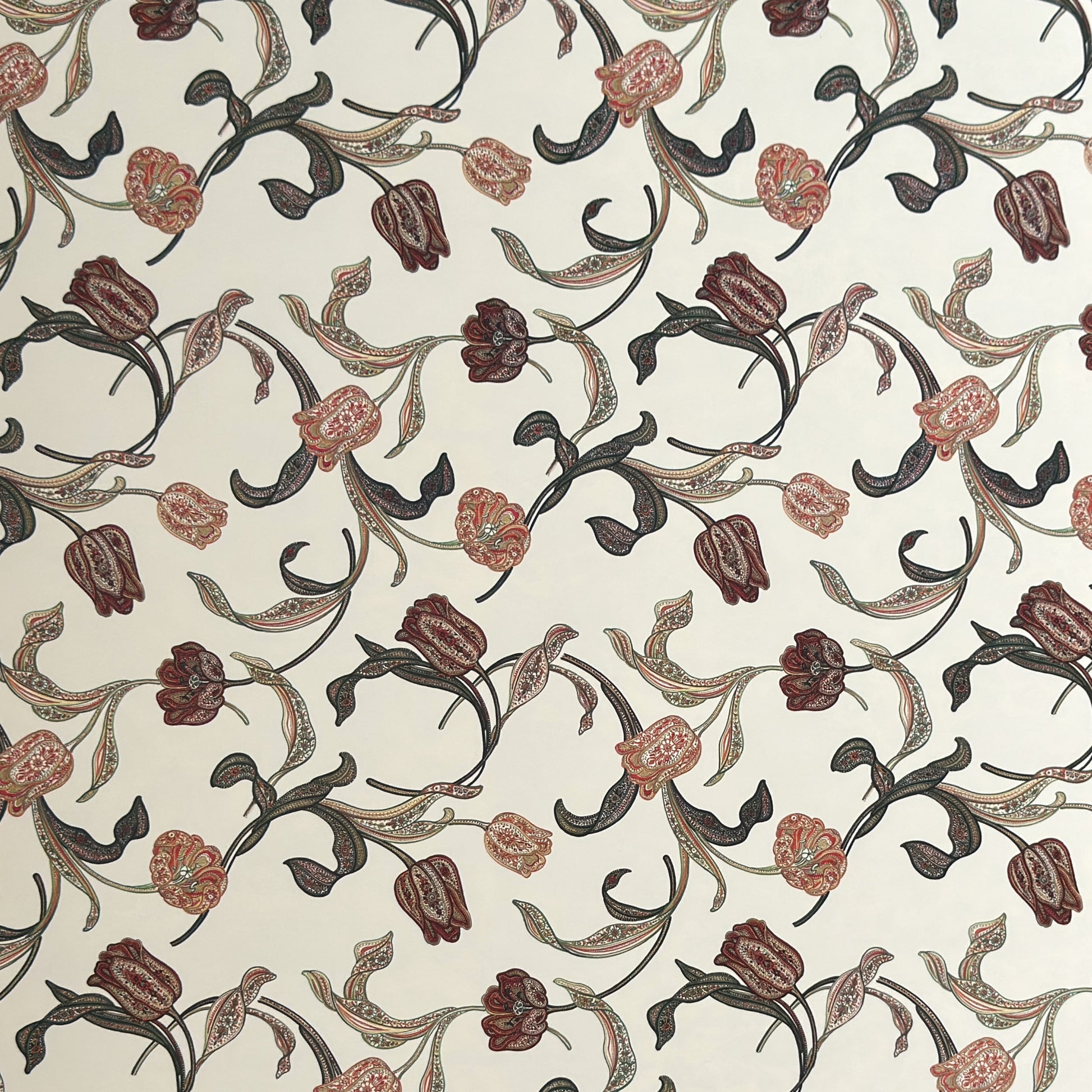 a sheet of italian wrapping paper with a multicoloured large floral pattern on cream paper 