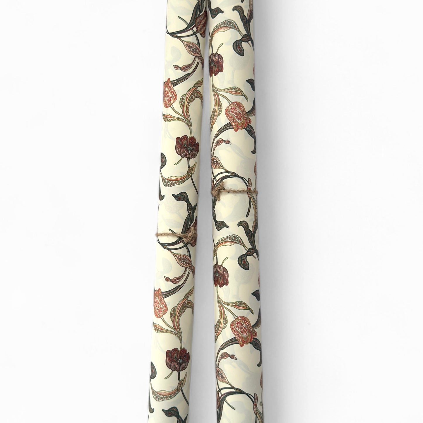 a sheet of italian wrapping paper with a multicoloured large floral pattern on cream paper. Pictured rolled 