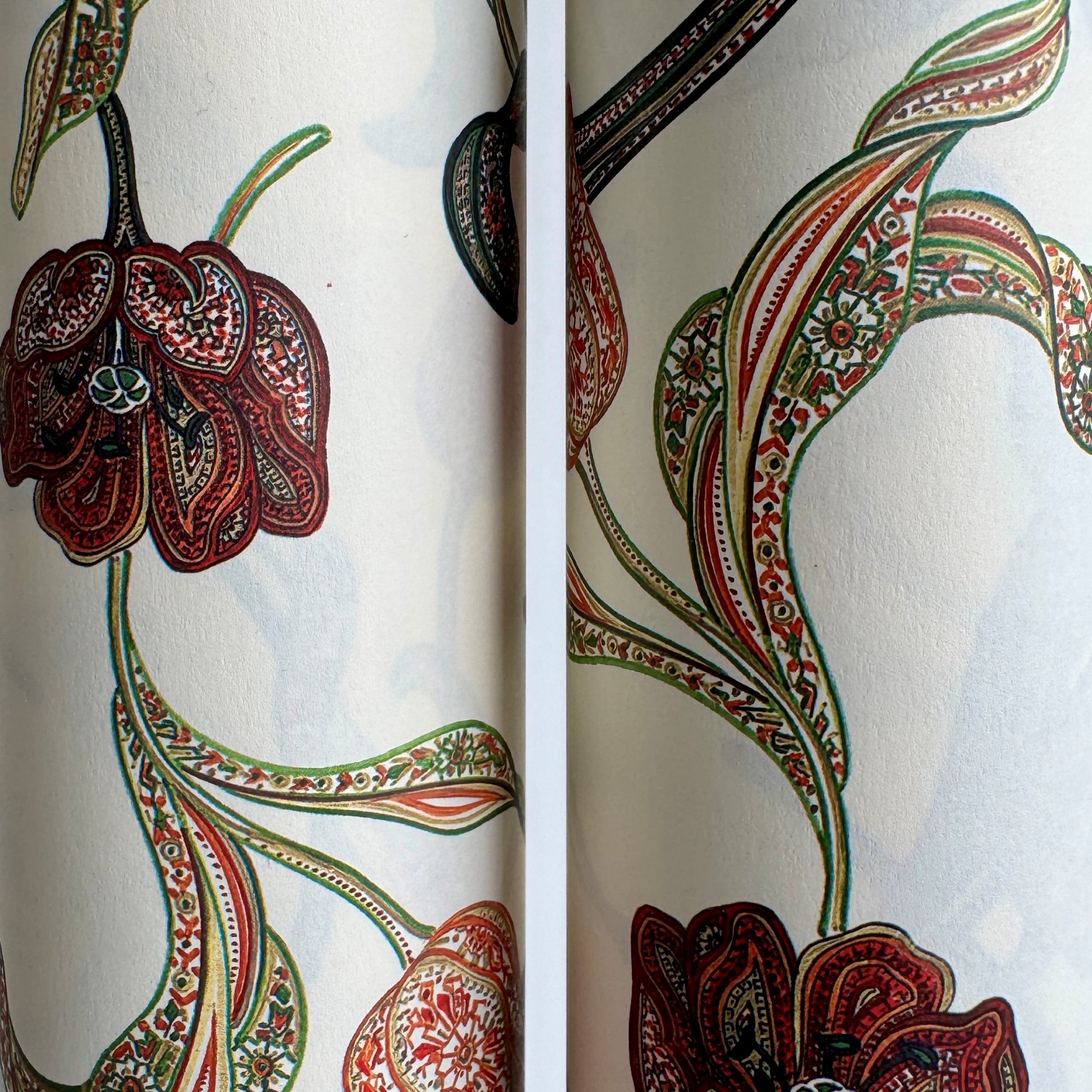 a sheet of italian wrapping paper with a multicoloured large floral pattern on cream paper 