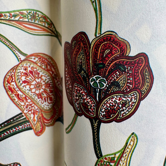 a sheet of italian wrapping paper with a multicoloured large floral pattern on cream paper 