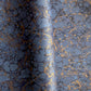 a sheet of Italian wrapping paper by Tassotti with a marbled pattern in dark and light blue with gold veins