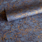 a sheet of Italian wrapping paper by Tassotti with a marbled pattern in dark and light blue with gold veins