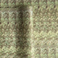 a sheet of Italian printed marbled paper by Tassotti with a marbled design in tones of green and cream
