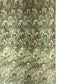 a sheet of Italian printed marbled paper by Tassotti with a marbled design in tones of green and cream