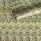a sheet of Italian printed marbled paper by Tassotti with a marbled design in tones of green and cream
