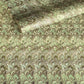 a sheet of Italian printed marbled paper by Tassotti with a marbled design in tones of green and cream