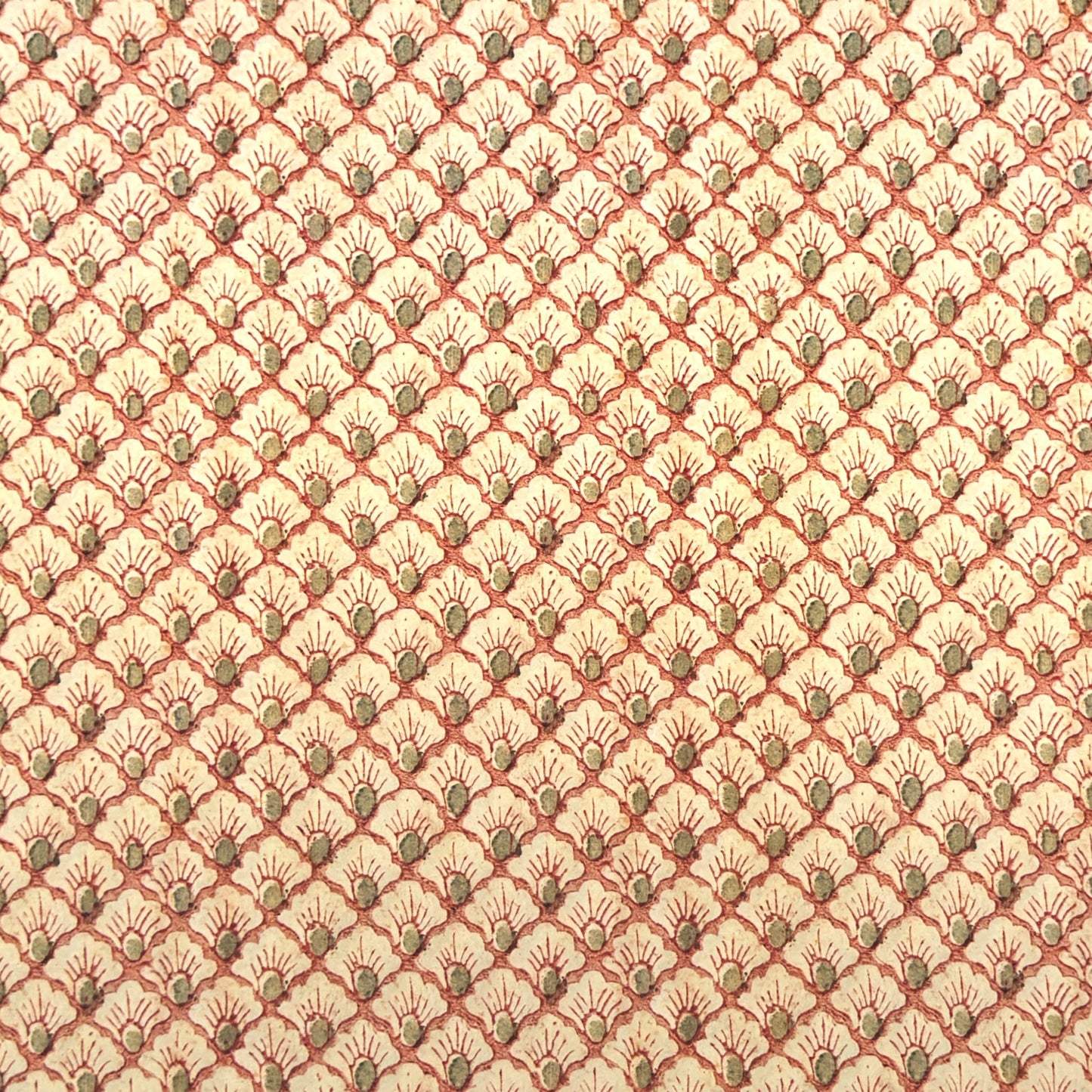 a sheet of italian wrapping paper with a shell repeat pattern in soft coral, cream and olive green