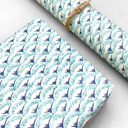 italian Remondini patterned wrapping paper by Tassotti..  All over repeat pattern of block printed style waves in aqua, dark blue on white background.