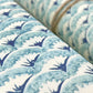 italian Remondini patterned wrapping paper by Tassotti.. All over repeat pattern of block printed style waves in aqua, dark blue on white background. Close-up