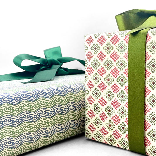 italian Remondini patterned wrapping paper by Tassotti. Block print style red and green diamonds on a white background. Wrapped as a present