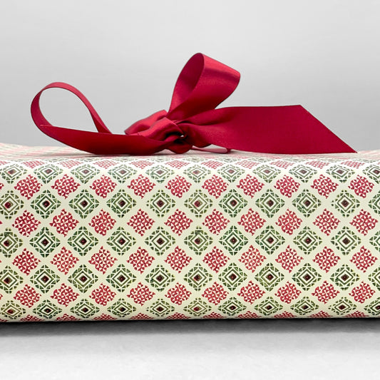 italian Remondini patterned wrapping paper by Tassotti. Block print style red and green diamonds on a white background
