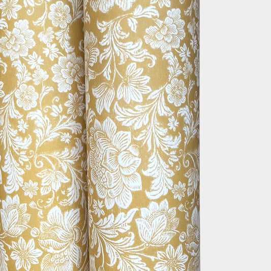 floral italian florentine wrapping paper with a white repeat floral on a mustard background
