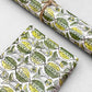 italian Remondini patterned wrapping paper by Tassotti. Block print style pattern with green leaves and flowers on a white background.