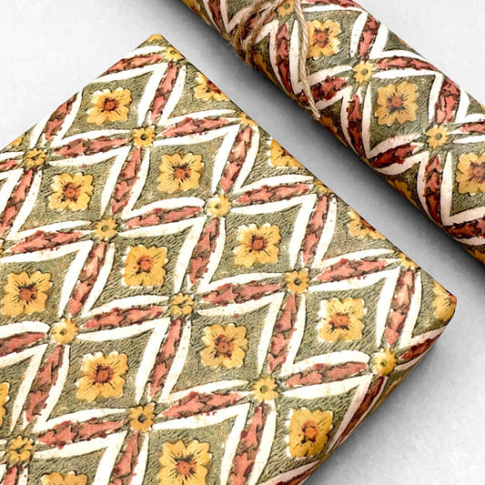 italian Remondini patterned wrapping paper by Tassotti. a repeat diamond pattern with flowers in sage green, soft peach and yellow on white background