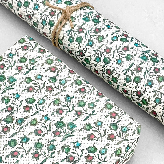 italian Remondini patterned wrapping paper by Tassotti.  Little floral repeat pattern of block print style flowers in blue, red and green on a white background