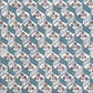 italian remondini florentine wrapping paper with a geometric rombi pattern in blue with a block print flower in pink on a white background