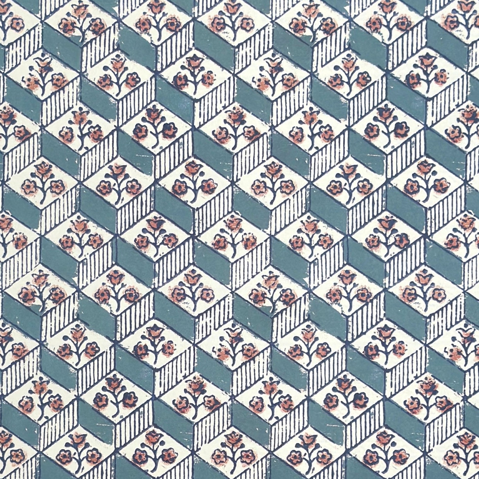 italian remondini florentine wrapping paper with a geometric rombi pattern in blue with a block print flower in pink on a white background