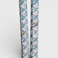 italian remondini florentine wrapping paper with a geometric rombi pattern in blue with a block print flower in pink on a white background. Picture rolled