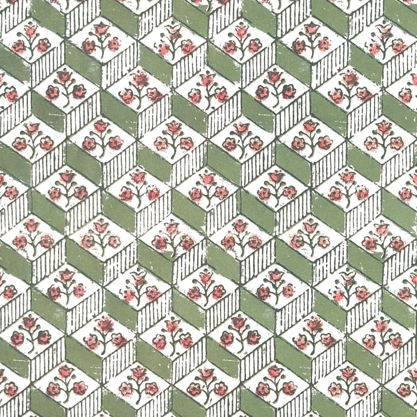 italian florentine wrapping paper with a geometric rombi design in green on white with a little block printed flower
