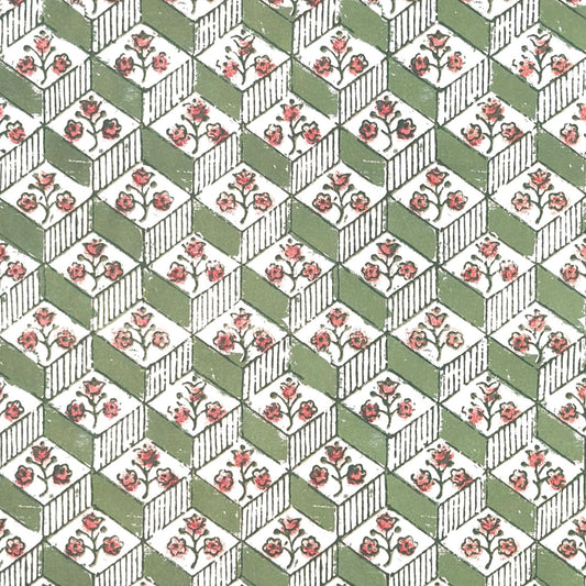 italian florentine wrapping paper with a geometric rombi design in green on white with a little block printed flower