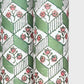 italian florentine wrapping paper with a geometric rombi design in green on white with a little block printed flower