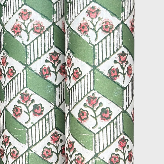 italian florentine wrapping paper with a geometric rombi design in green on white with a little block printed flower