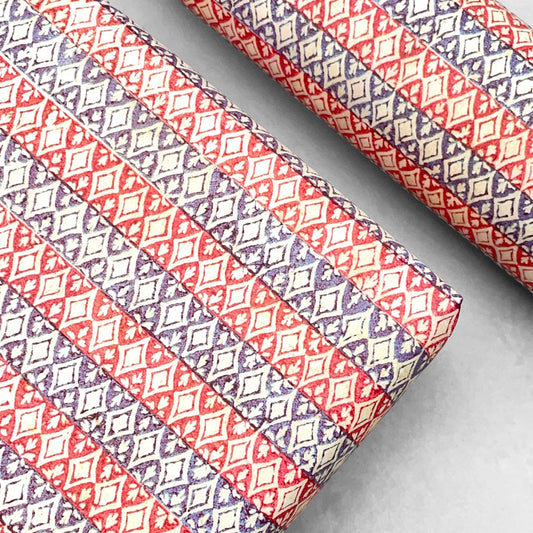 italian Remondini patterned wrapping paper by Tassotti. Striped design with bands red and blue with a cut out diamond effect in cream