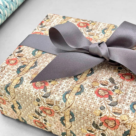 Remondini Italian patterned wrapping paper by Tassotti, A detailed trellis design with flowers in taupe, rose and aqua colours.  Pictured wrapped with a grey ribbon bow