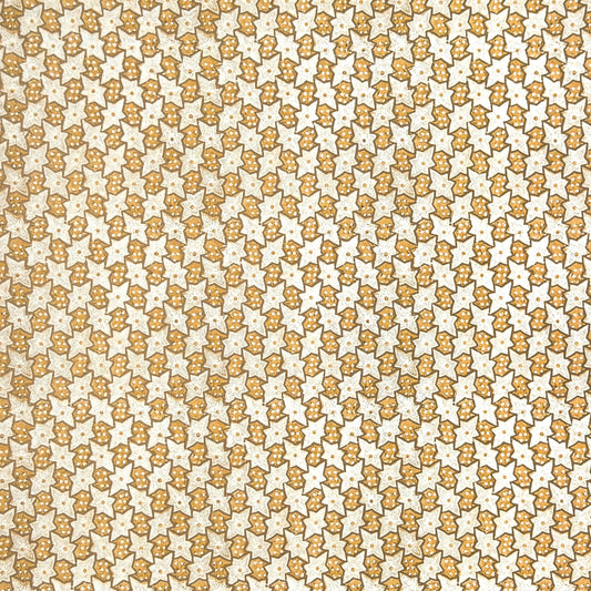 a sheet of italian wrapping paper with a star pattern in yellow, gold and white.