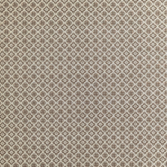 a sheet of italian wrapping paper with a small repeat geometric - floral pattern in brown and white