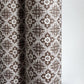 a sheet of italian wrapping paper with a small repeat geometric - floral pattern in brown and white